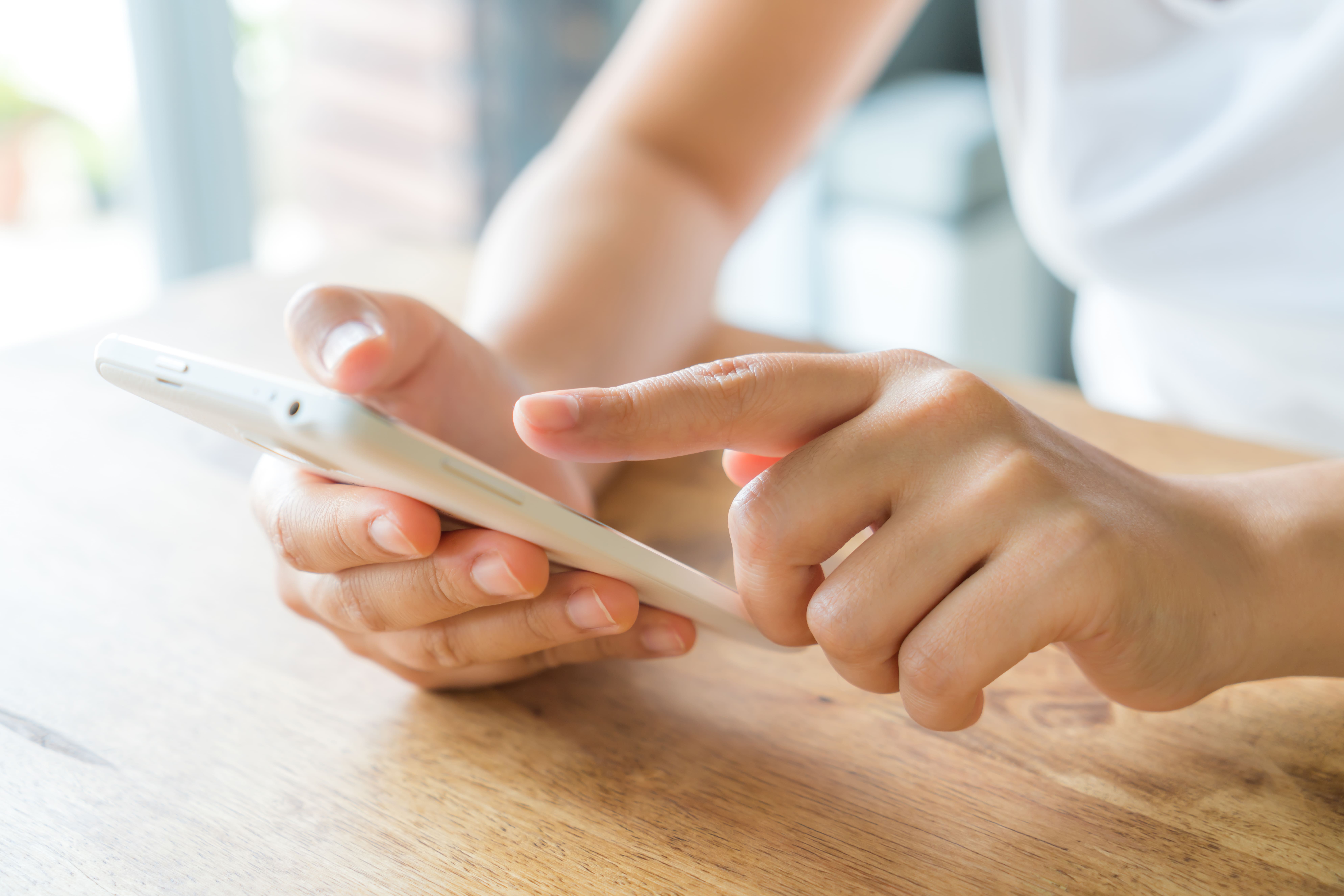 hands-touching-smartphone