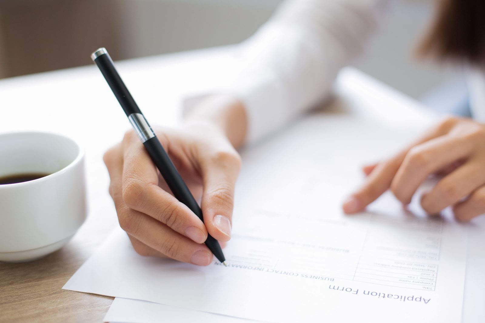 closeup-applicant-completing-application-form
