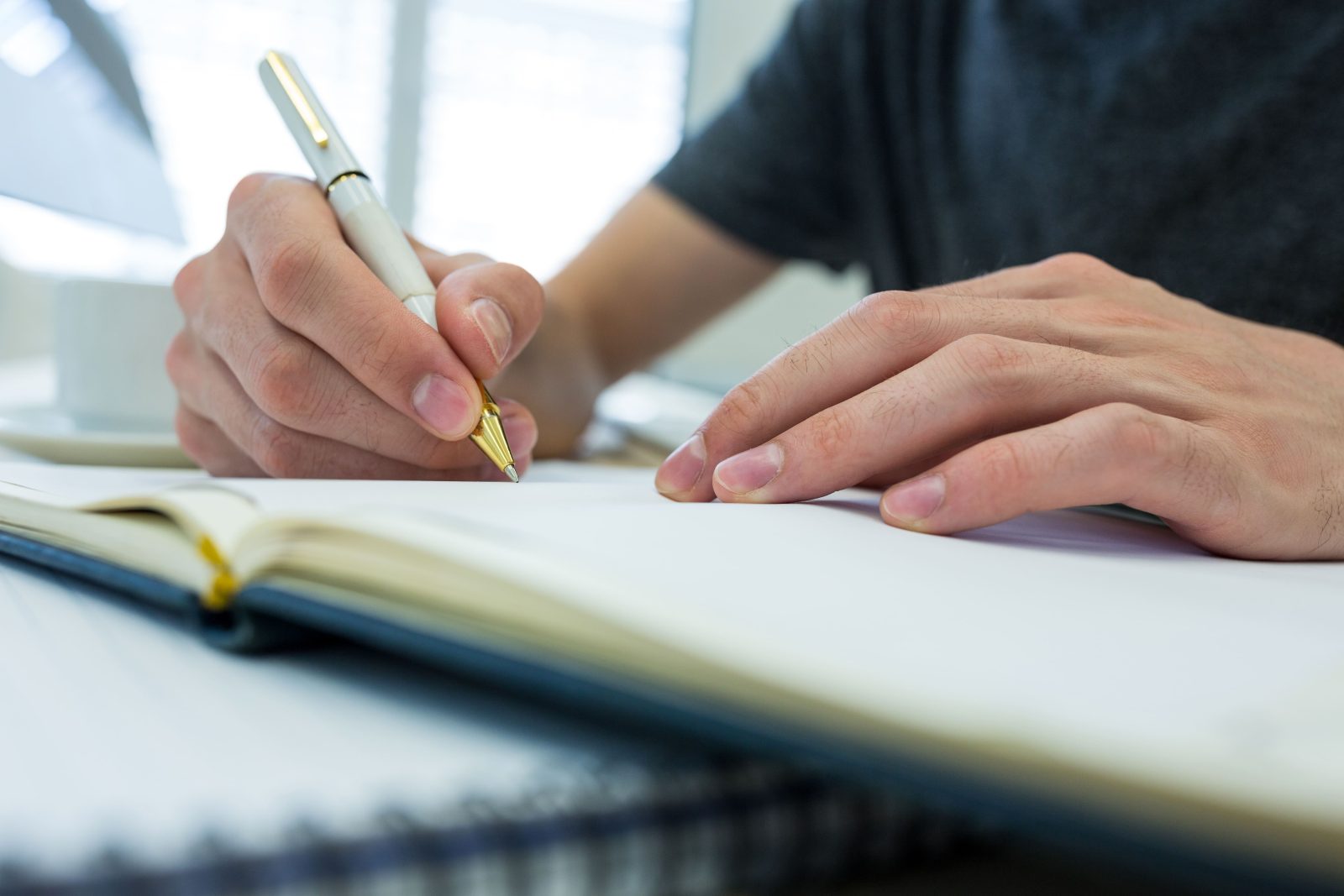 hands-male-graphic-designer-writing-diary