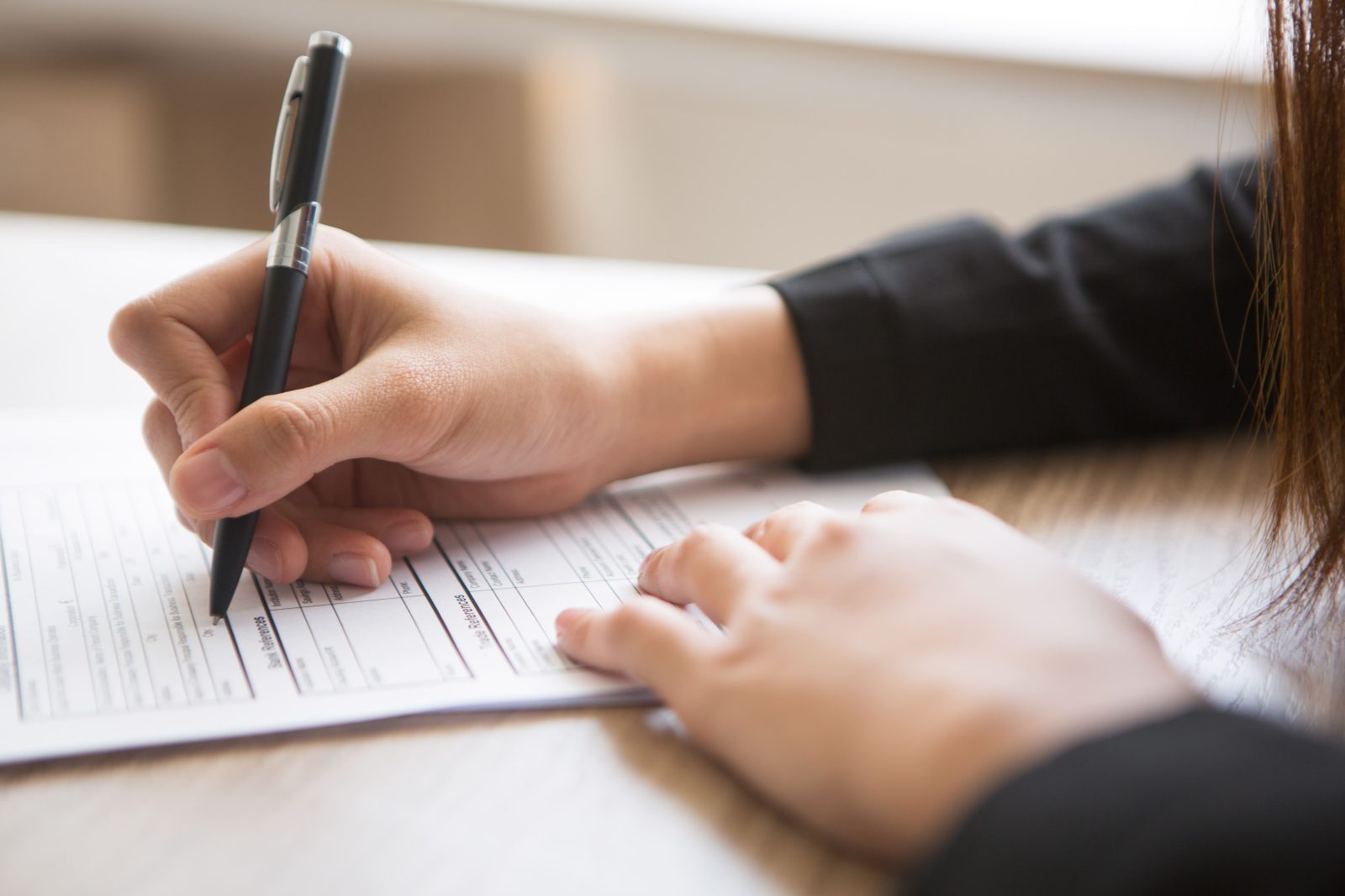 cropped-view-woman-filling-application-form