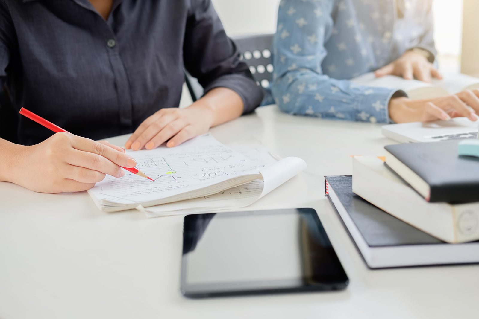 midsection-female-colleagues-working-desk-office