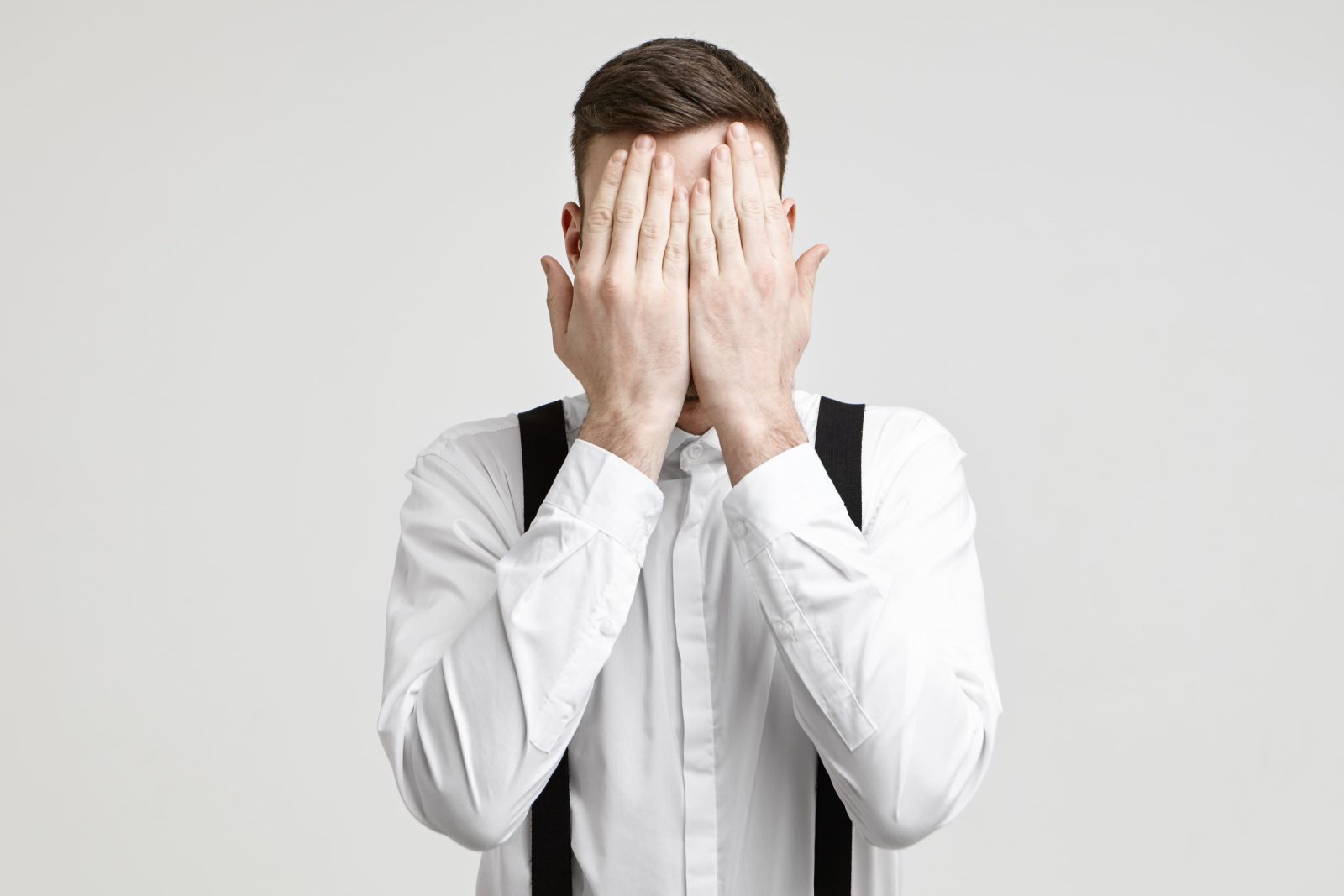body-language-non-verbal-communication-concept-isolated-shot-unrecognizable-european-male-wearing-white-formal-shirt-with-suspenders-covering-face-with-both-palms-feeling-stressed-tired