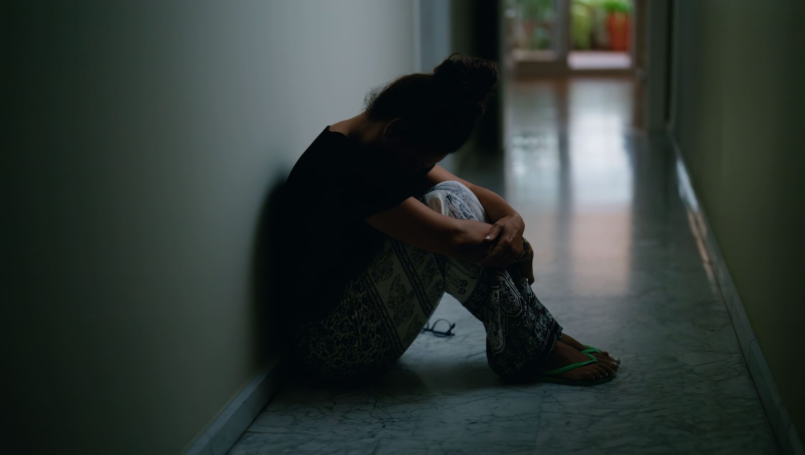 middle-age-hispanic-woman-suffering-domestic-violence-with-bruise-eyes-sitting-floor-home