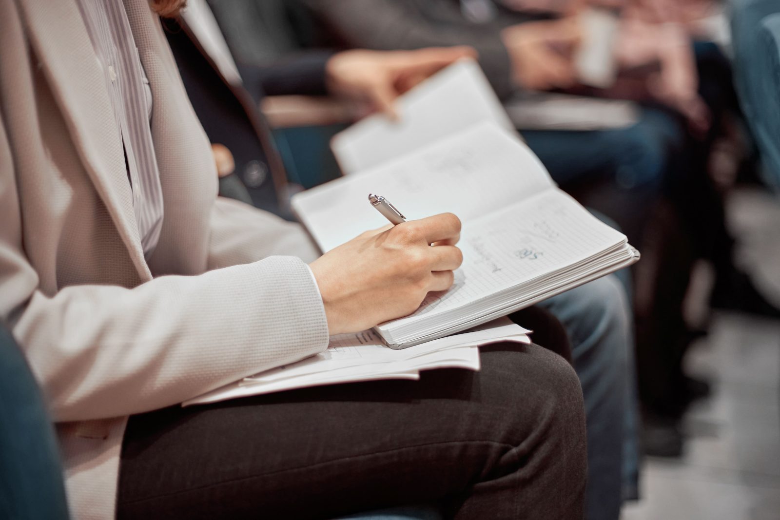 business-woman-taking-notes-her-notebook