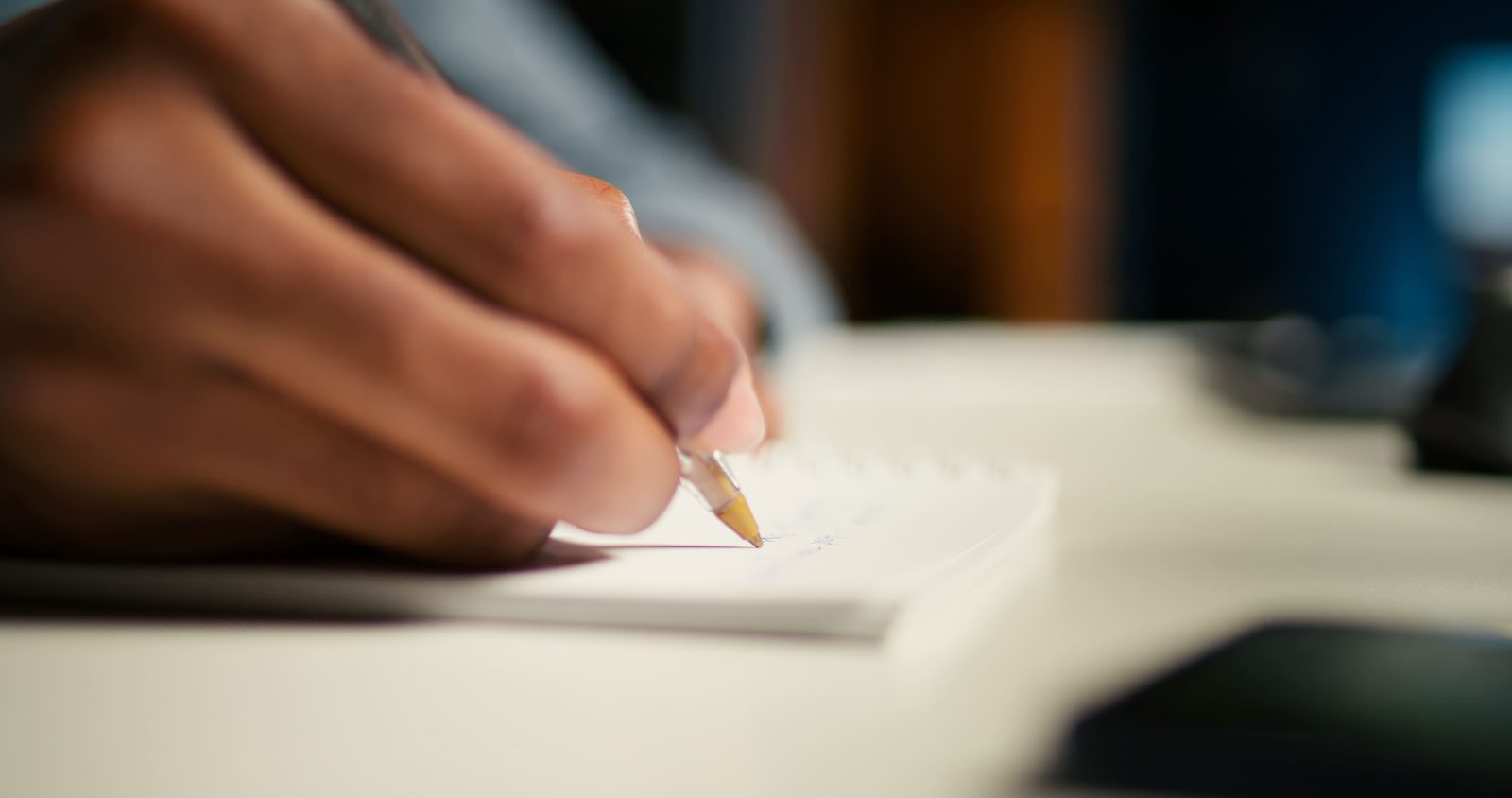 black-freelancer-researching-online-data-writing-notes-articles