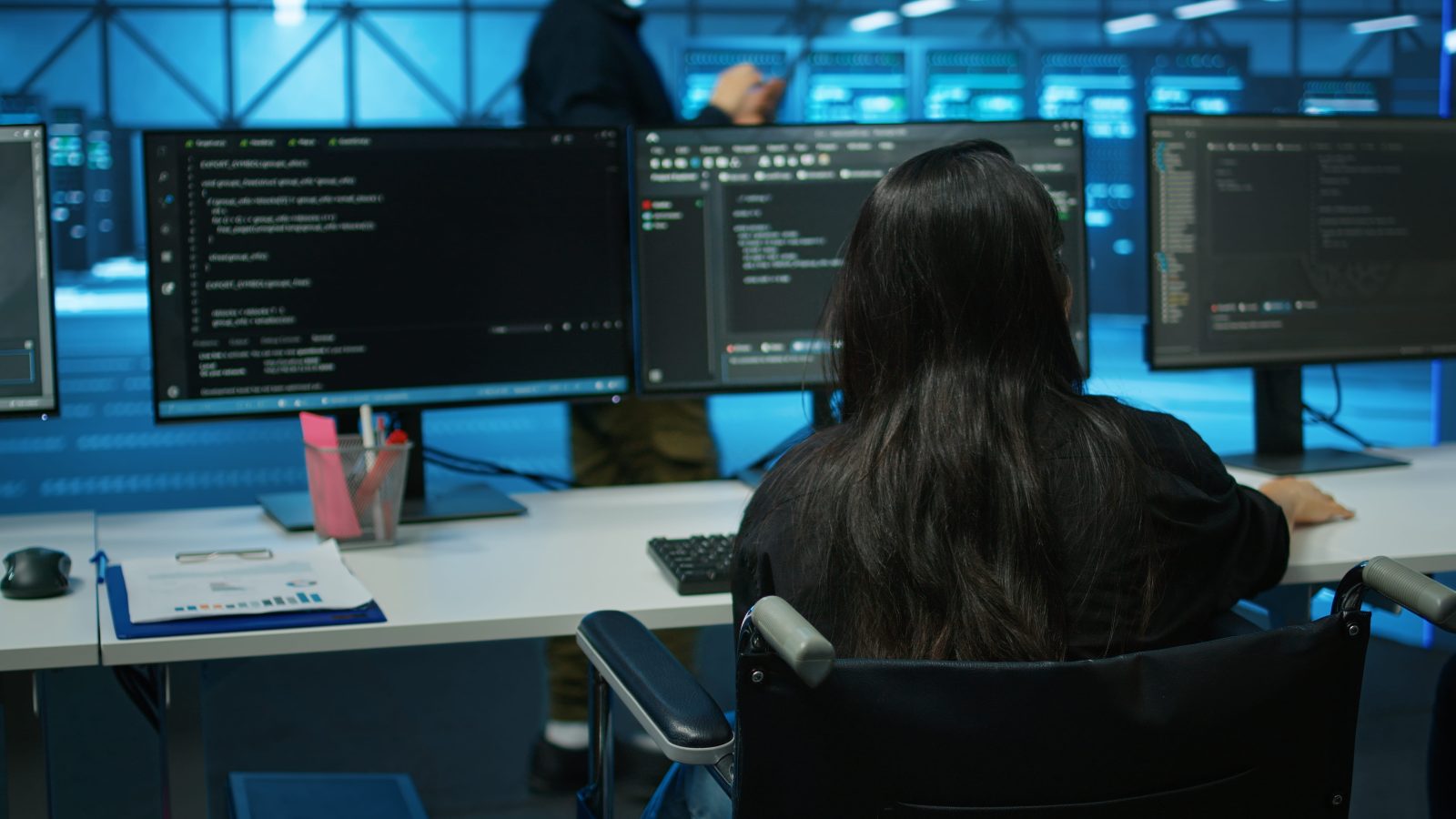 wheelchair-user-data-center-reading-paperwork-reviewing-rigs-performance