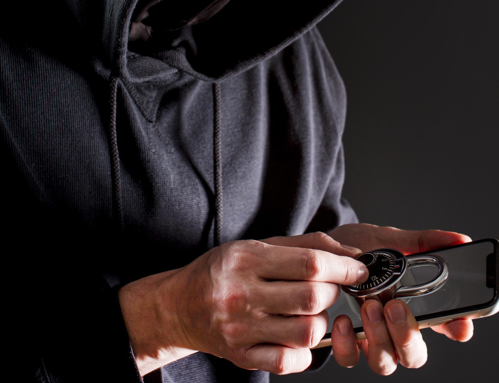 side-view-male-hacker-holding-smartphone-lock 1