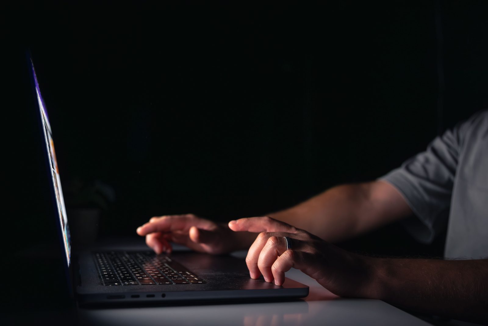 young-man-works-computer-night