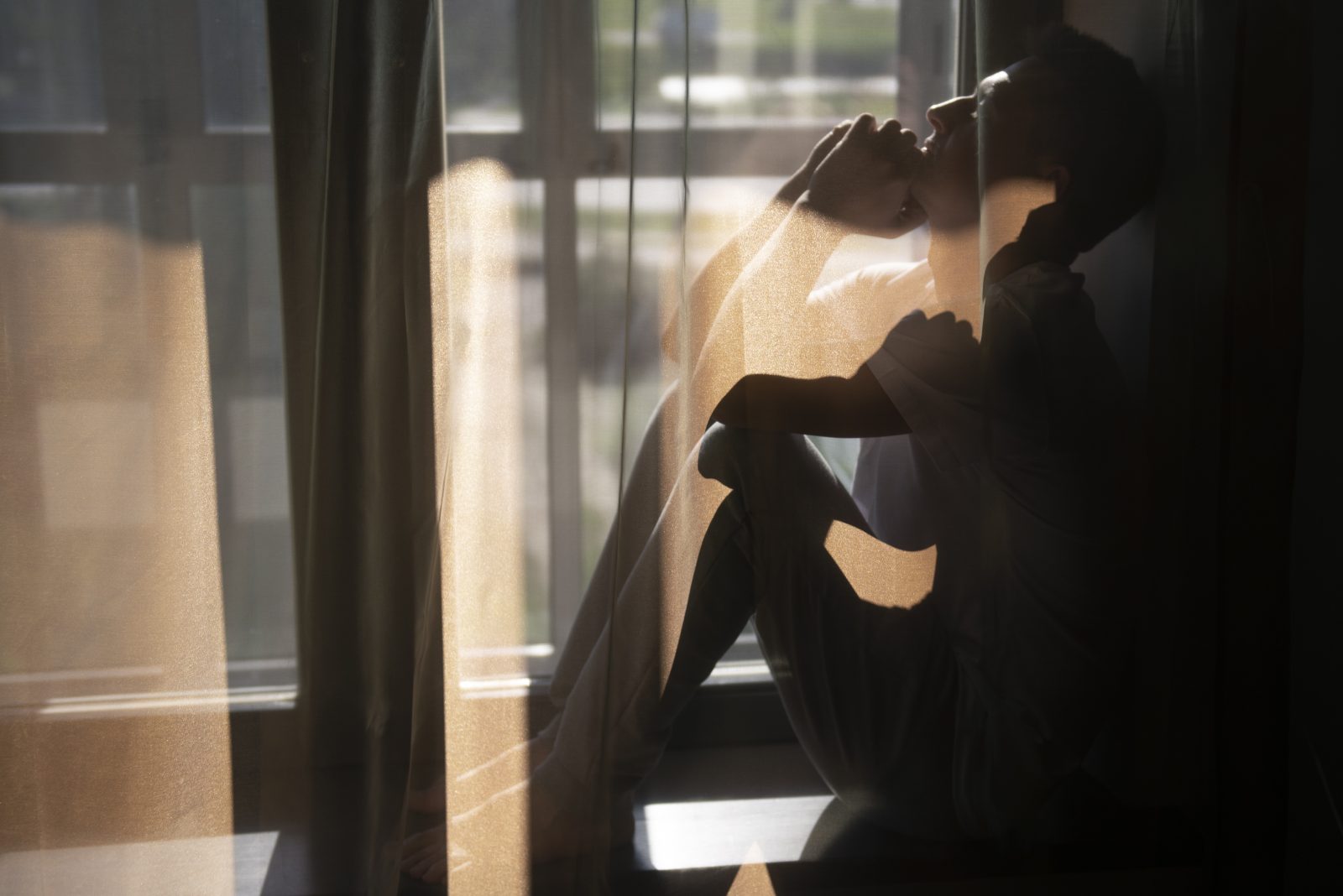 creative-portrait-man-with-curtains-shadows-from-window