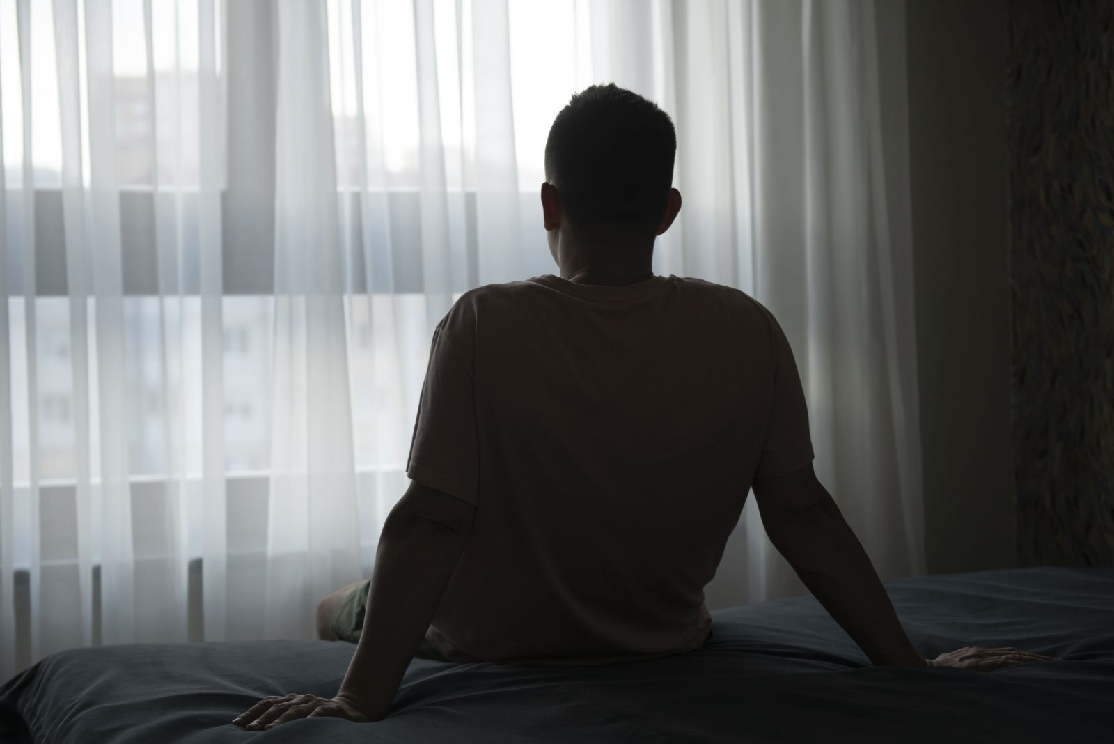 portrait-adult-man-with-curtains-shadow-from-window